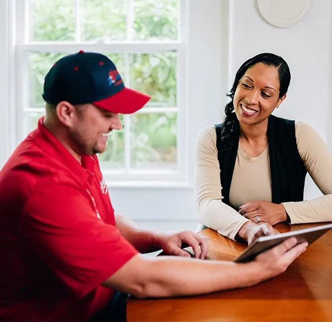 A Rainbow Restoration representative discusses property restoration services with a homeowner in Stockton, CA.
