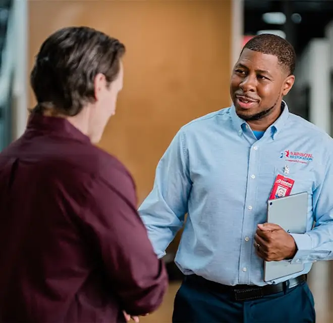 A Rainbow Restoration project manager greets a property owner dealing with a commercial water damage loss in New Orleans, LA.