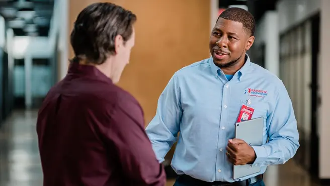 A Rainbow Restoration project manager greets a property owner dealing with a commercial loss in Boiling Springs, SC.