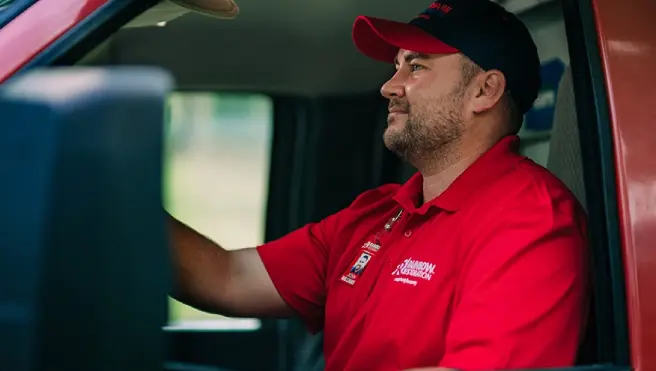 A Rainbow Restoration Emergency Response Team member drives to a property.