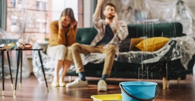 A couple in Duncan, SC, calls a water damage restoration company as water drips from the ceiling in their living room.
