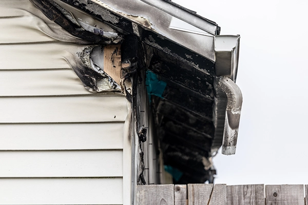 A home in Simpsonville, SC, with fire damage to the roof and siding.