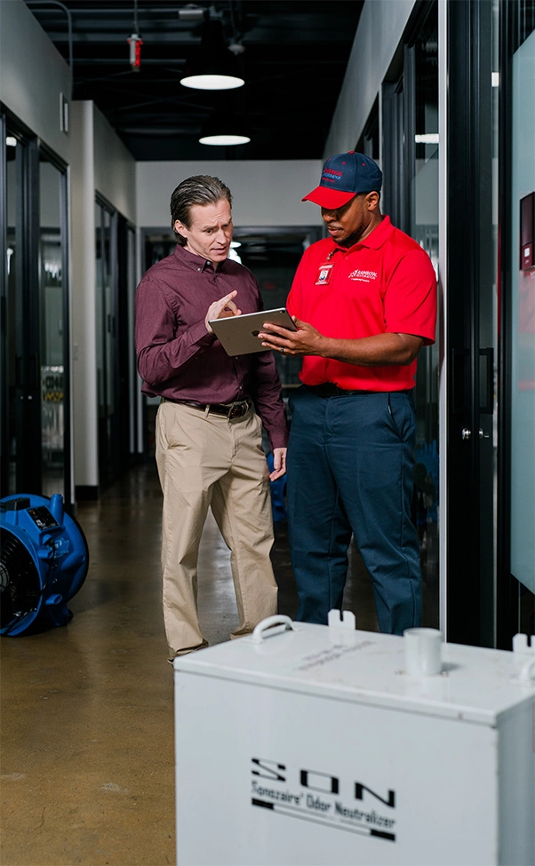 A Rainbow Restoration team member answers a question from a commercial restoration customer in Greer, SC.