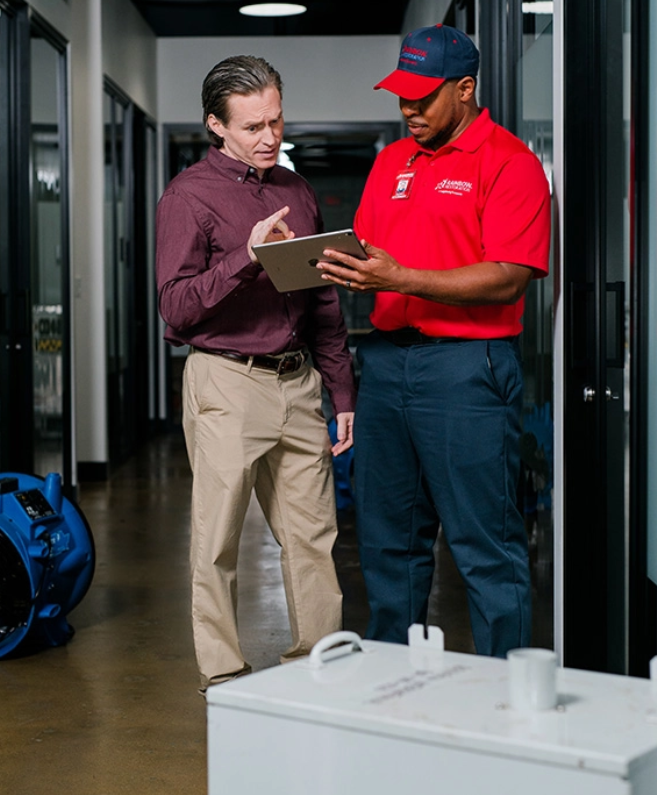 A Rainbow Restoration team member answers a question from a commercial restoration customer in Thornton, CO.