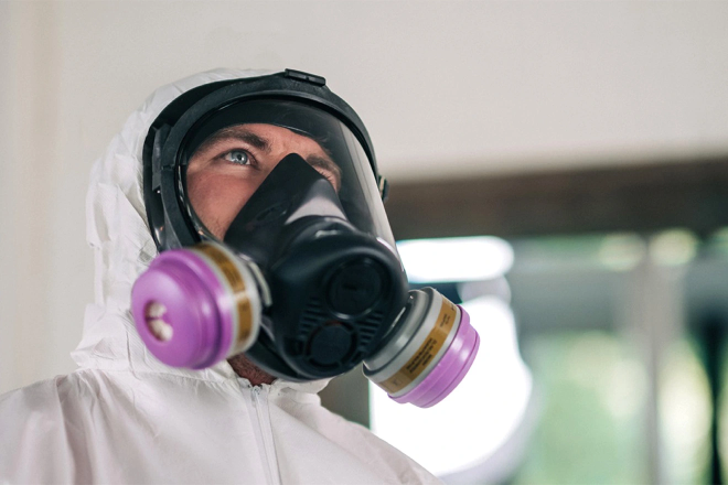 Rainbow Restoration service professional in proper mold removal attire.