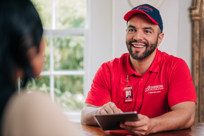 A Rainbow Restoration service professional gives a homeowner advice on preventing sewer backups.