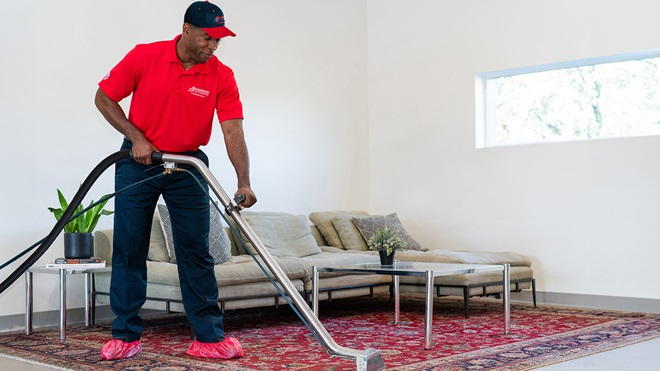 A Rainbow Restoration service professional provides carpet cleaning services.