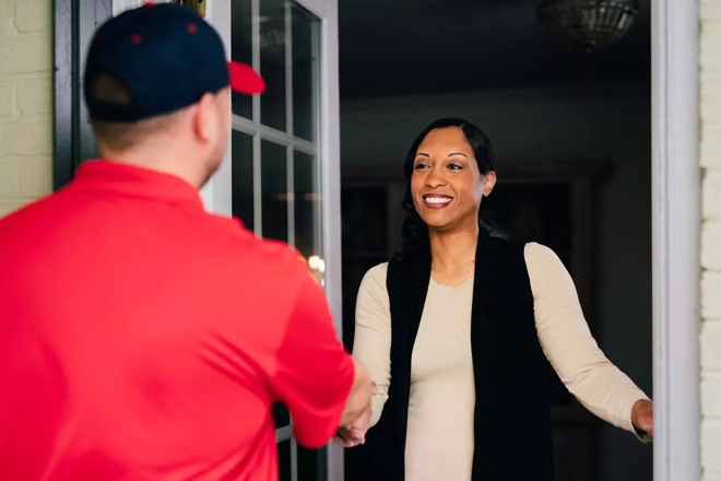 Rainbow Restoration service professional greets an occupant at the door.