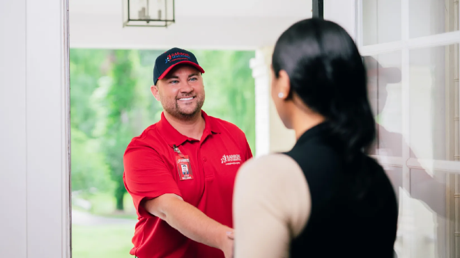 A Rainbow Restoration service professional helps a customer with a sewage backup.