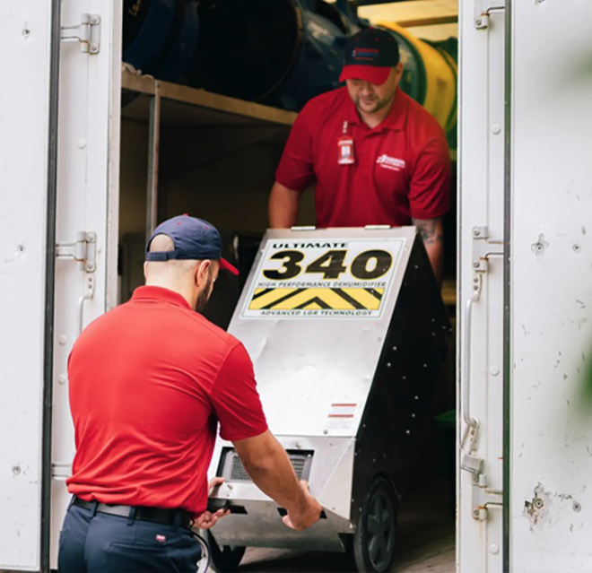 Rainbow Restoration service professionals unloading a commercial-grade dehumidifier.