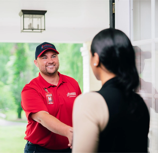 A Rainbow Restoration expert greets a Deschutes River Woods, OR, homeowner in need of emergency restoration services at their front door.