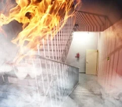 A fire with heavy smoke in the stairwell of a building.