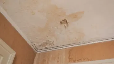 Water damage on the ceiling of a room.