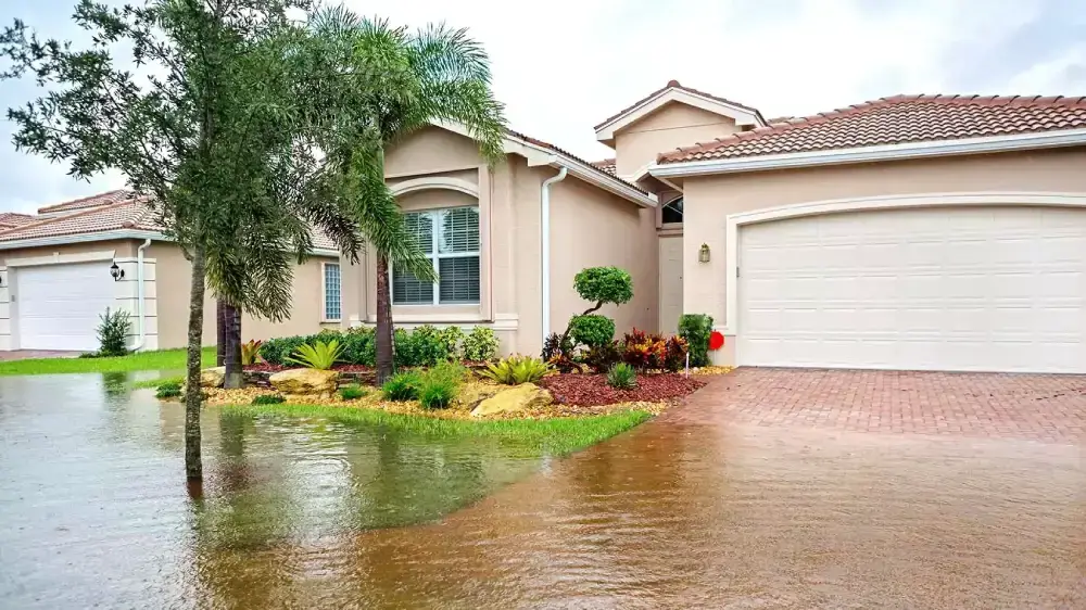 House with flooded driveway and front yard.